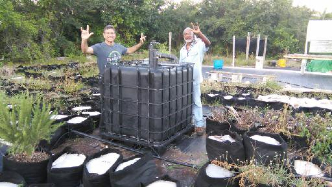 T.H.and Alex celebrate the siting of Alex's new IBC Biodigester as the liquid composting centerpiece to his garden education center.